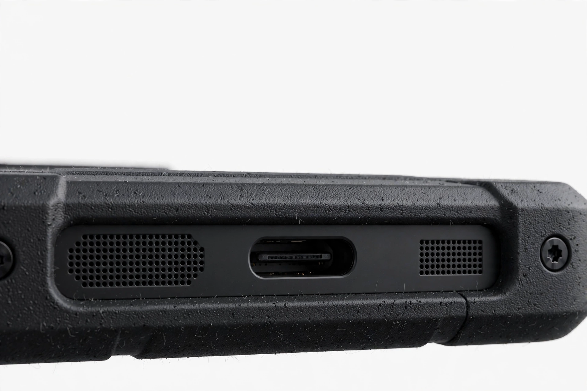 Close-up of smartphone bottom edge speaker grille and charging port