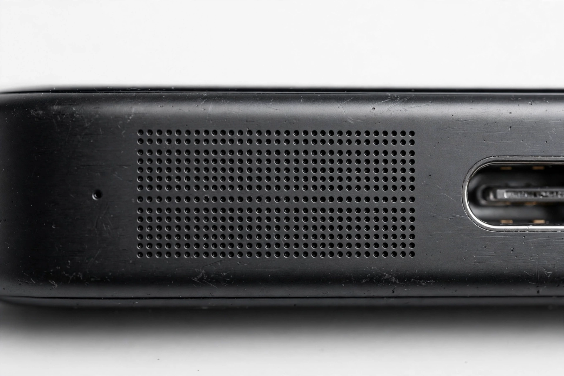 Close-up of a smartphone speaker grille for troubleshooting audio issues