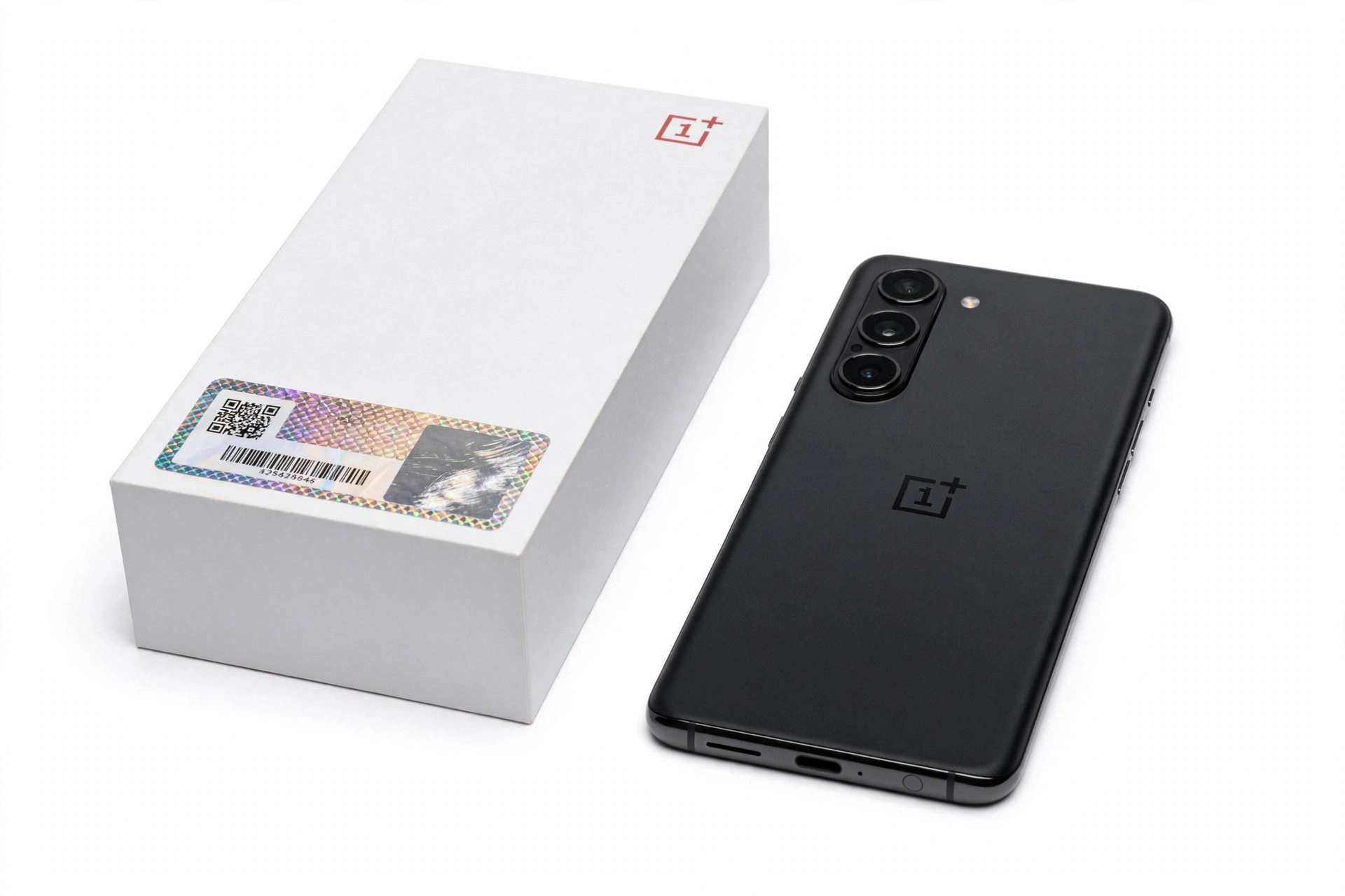 OnePlus smartphone next to its retail box with serial number verification label