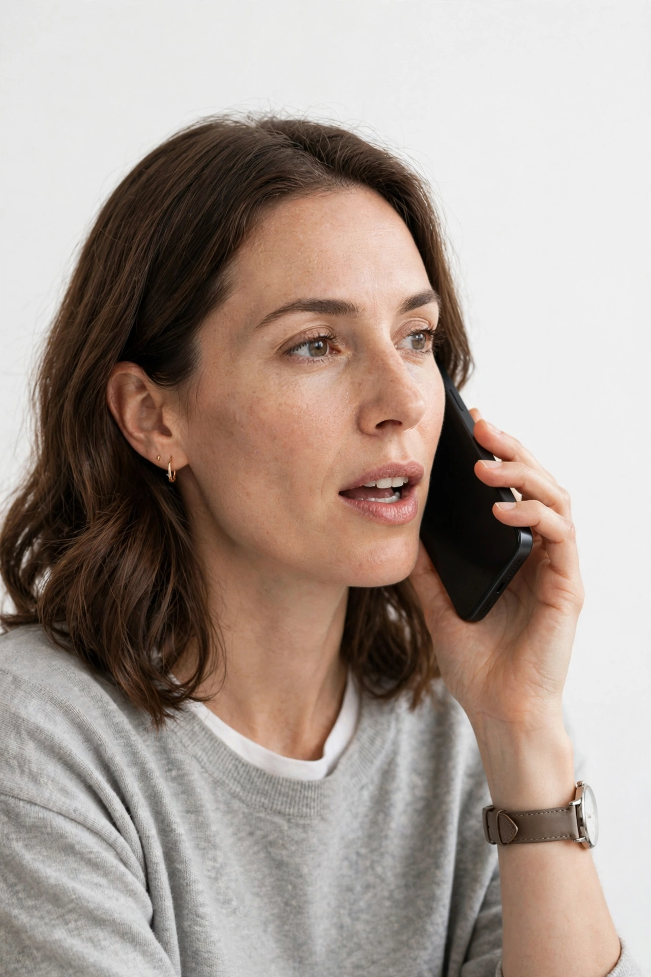 Person testing a smartphone microphone during a phone call