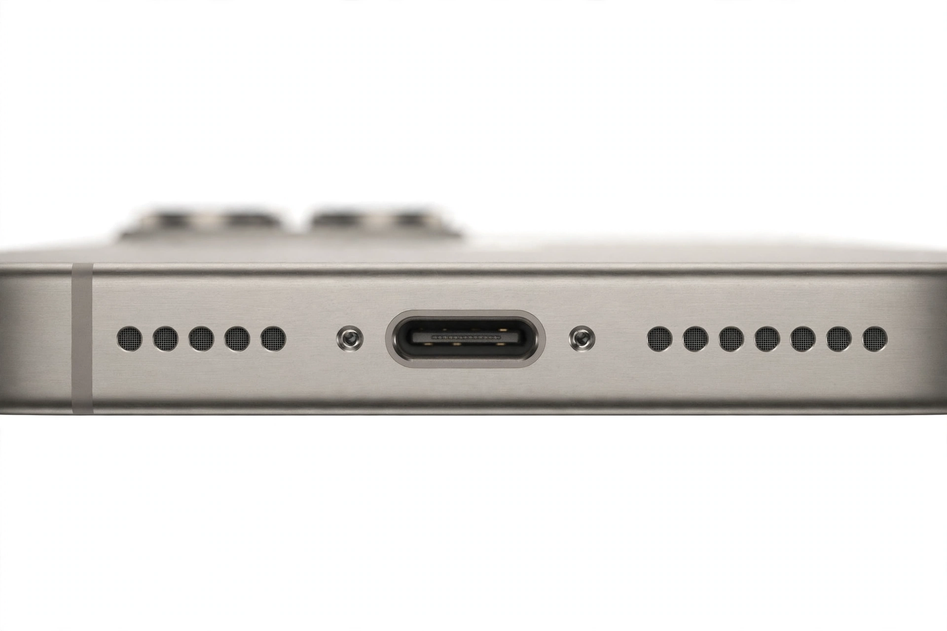 Macro close-up of an iPhone bottom edge microphone pinhole and speaker grille