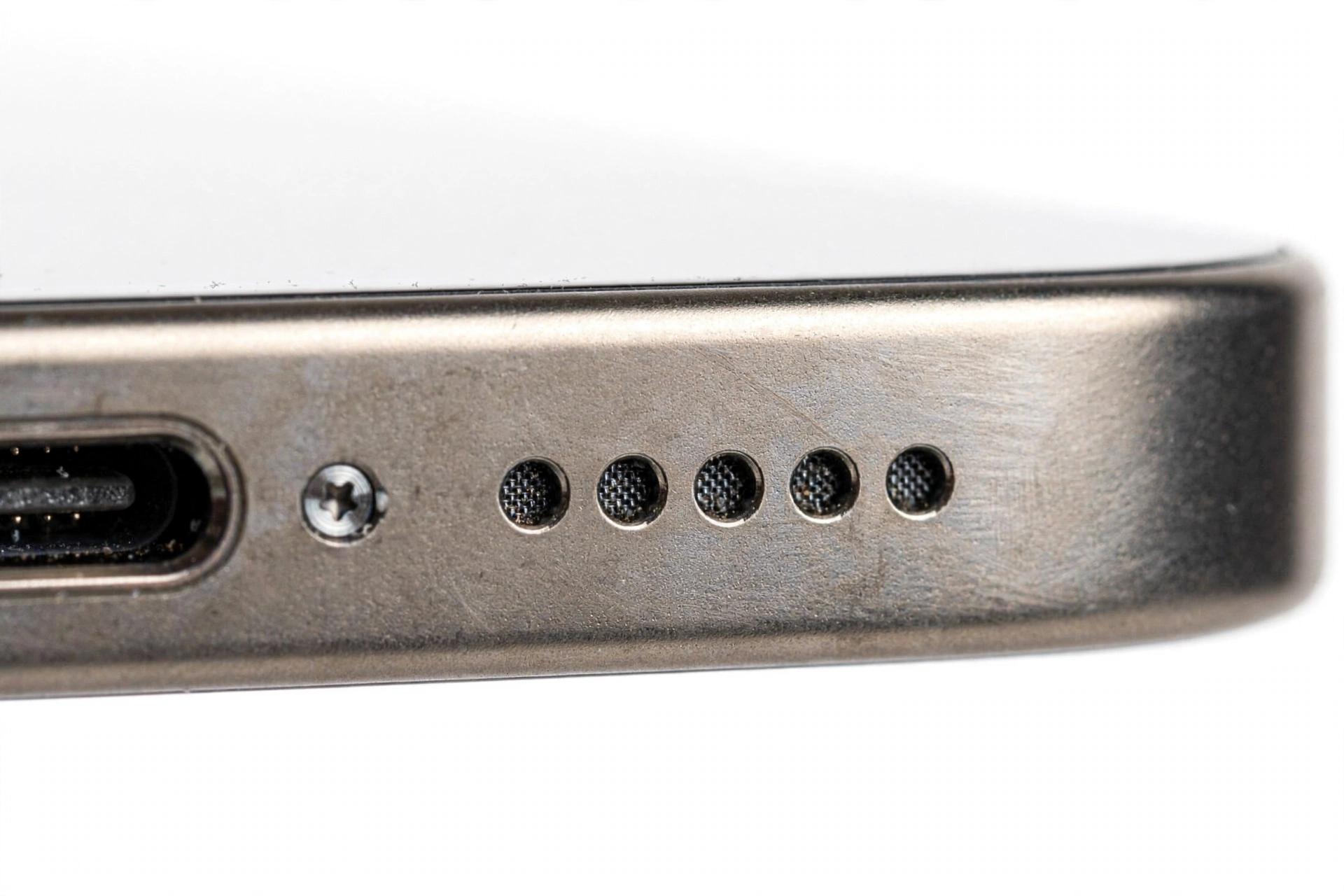 Macro close-up of an iPhone bottom edge speaker grille