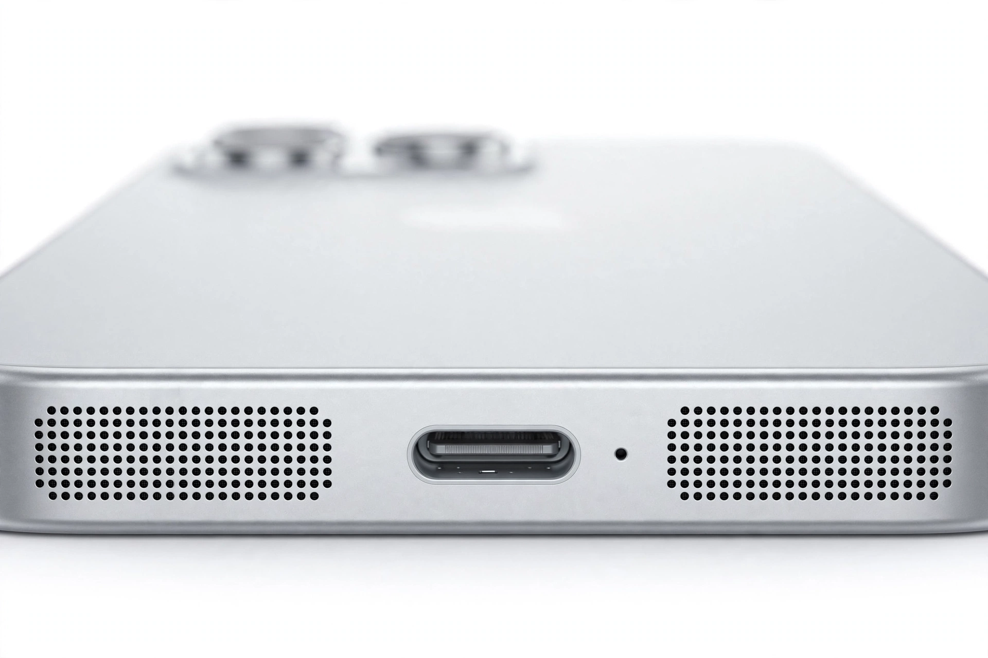 Macro close-up of smartphone bottom edge speaker grille