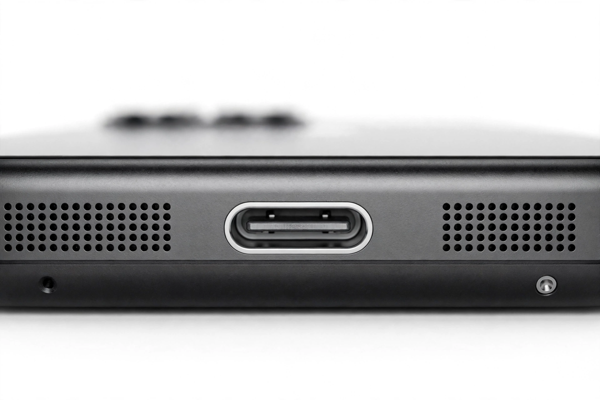 Macro close-up of a smartphone speaker grille and charging port