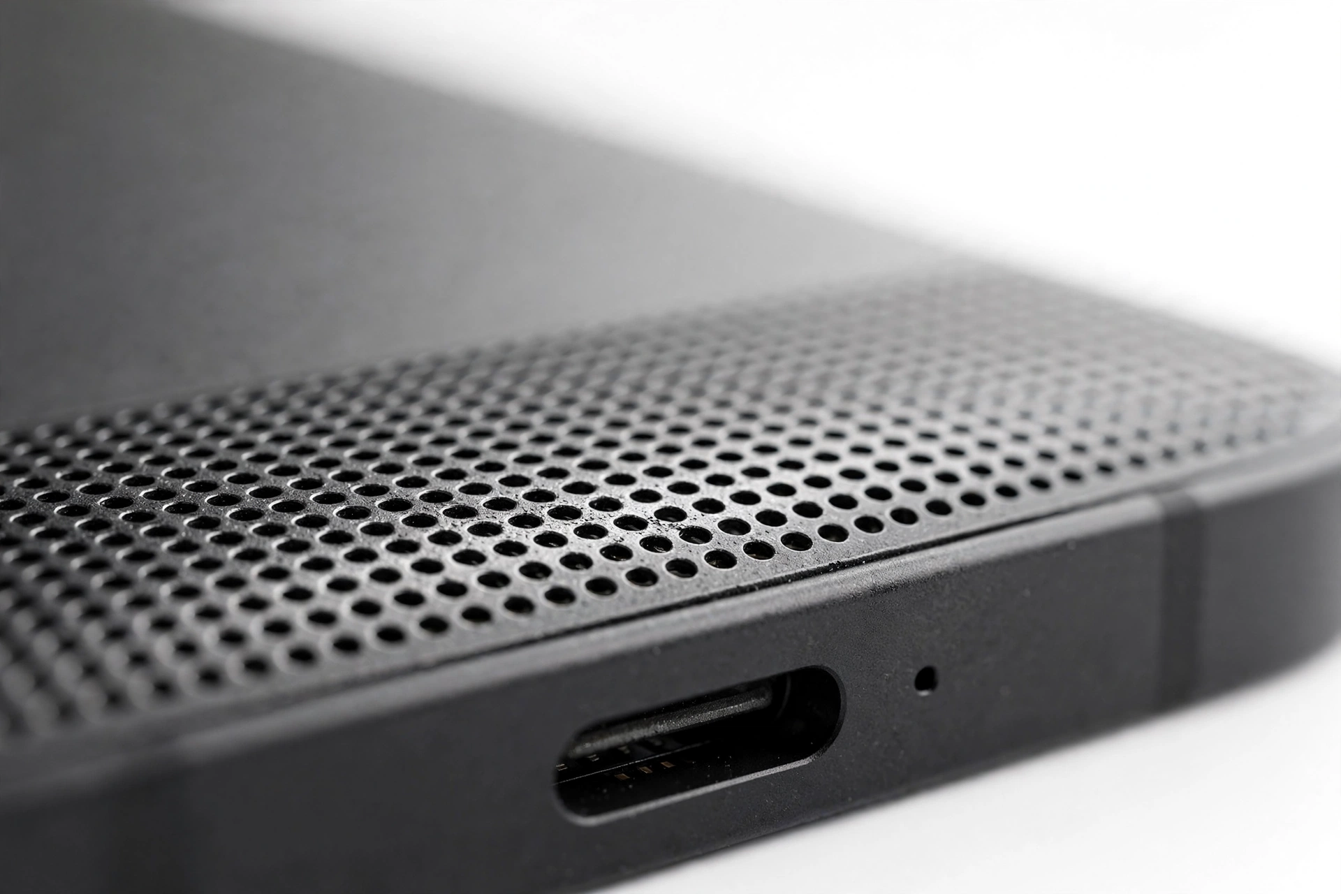Close-up of a smartphone bottom speaker grille