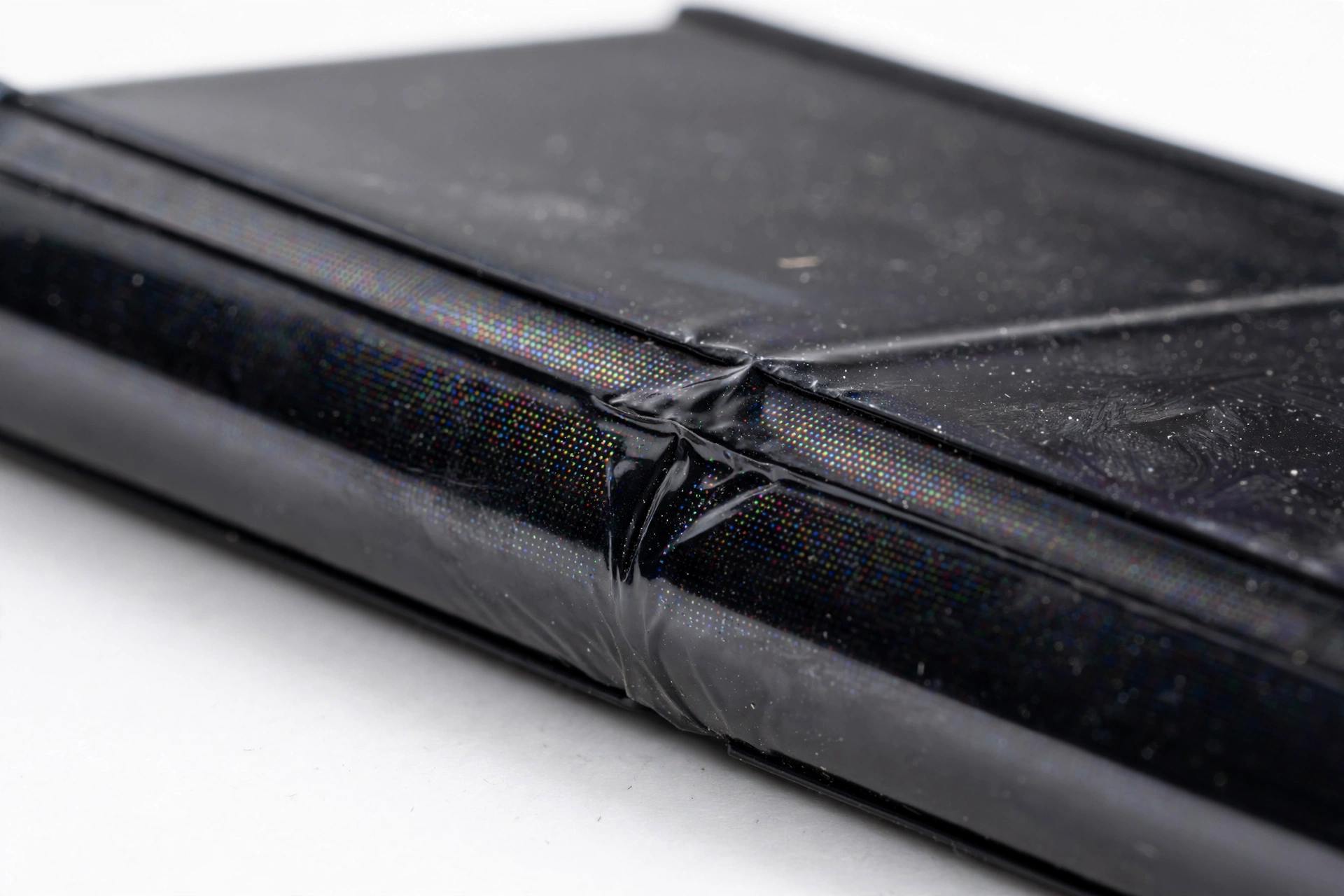 Close-up of foldable flip phone screen at the folding crease