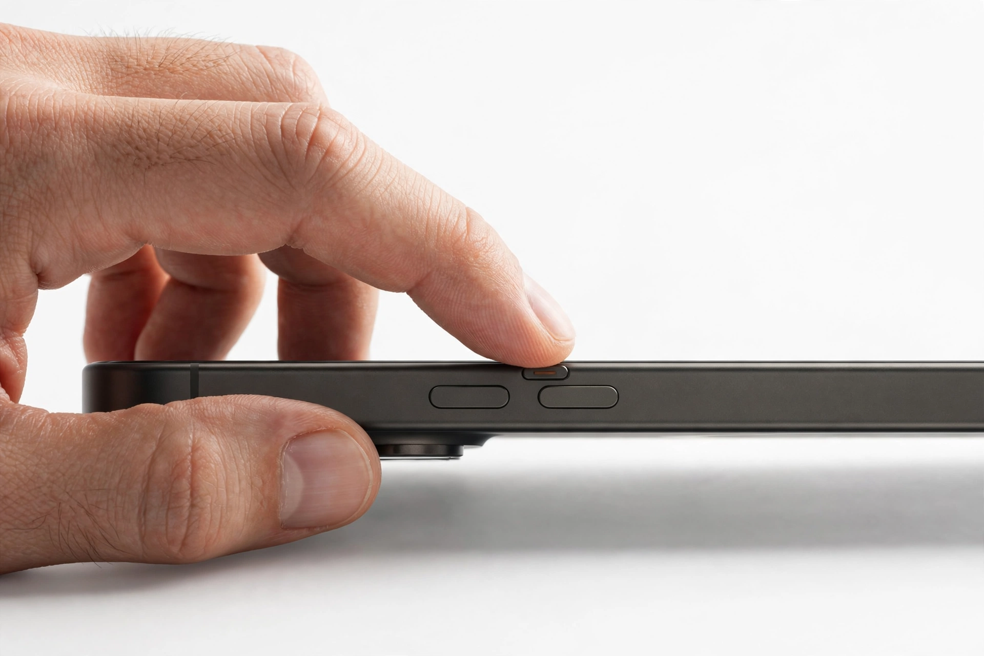 Hand toggling the silent switch on a smartphone
