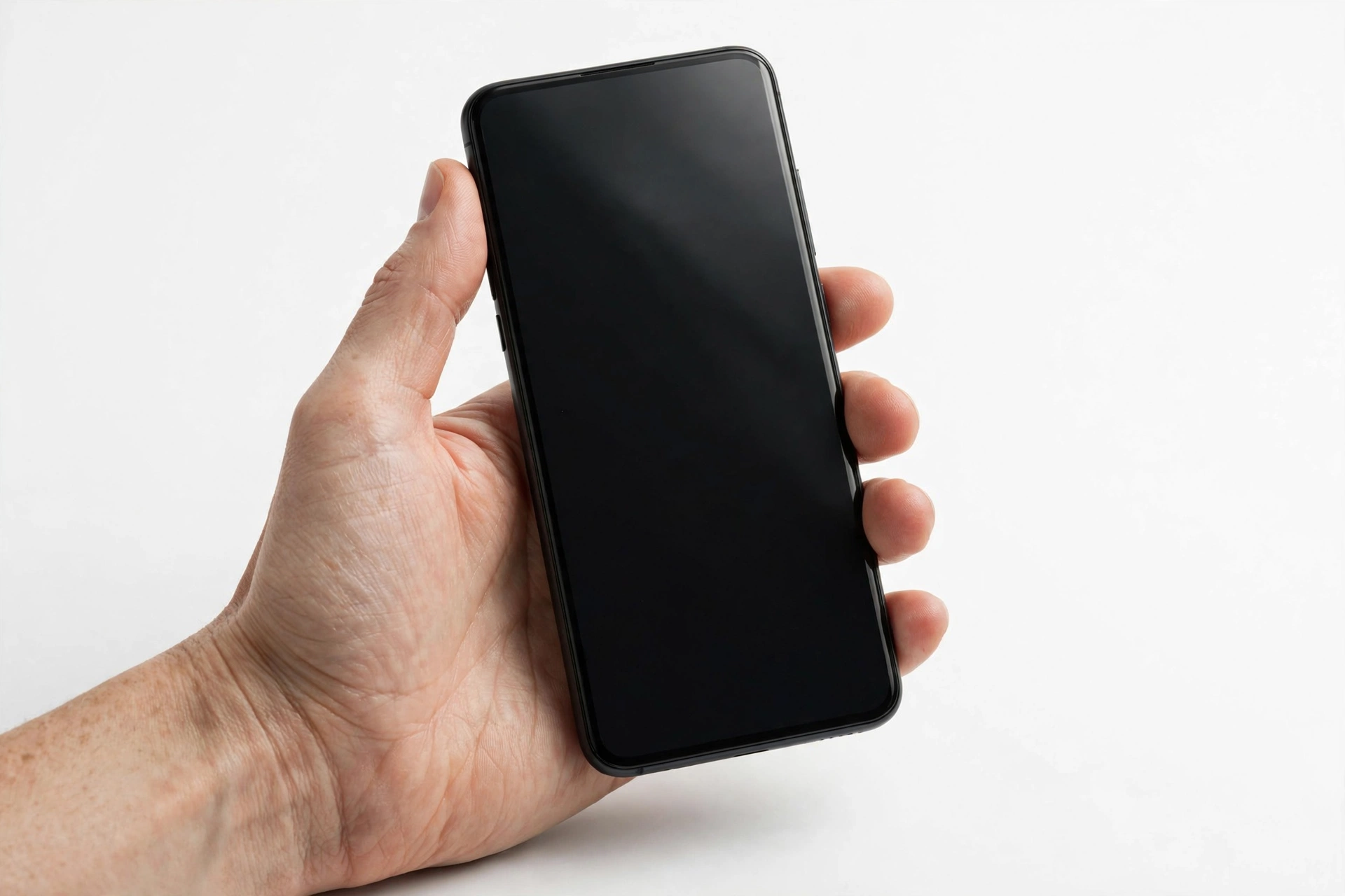 Smartphone with a black screen held in a hand
