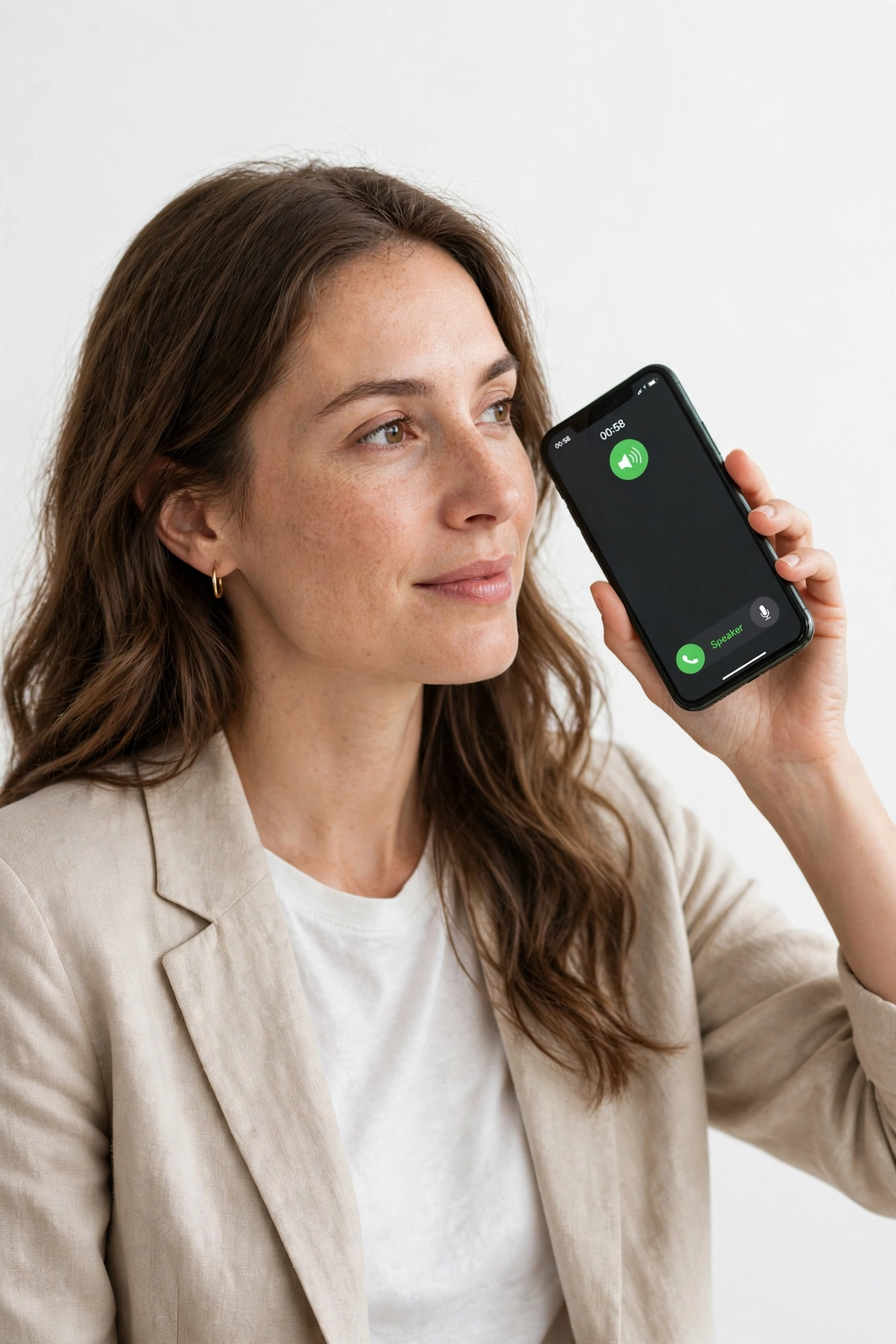 Person holding a smartphone on speakerphone during a call