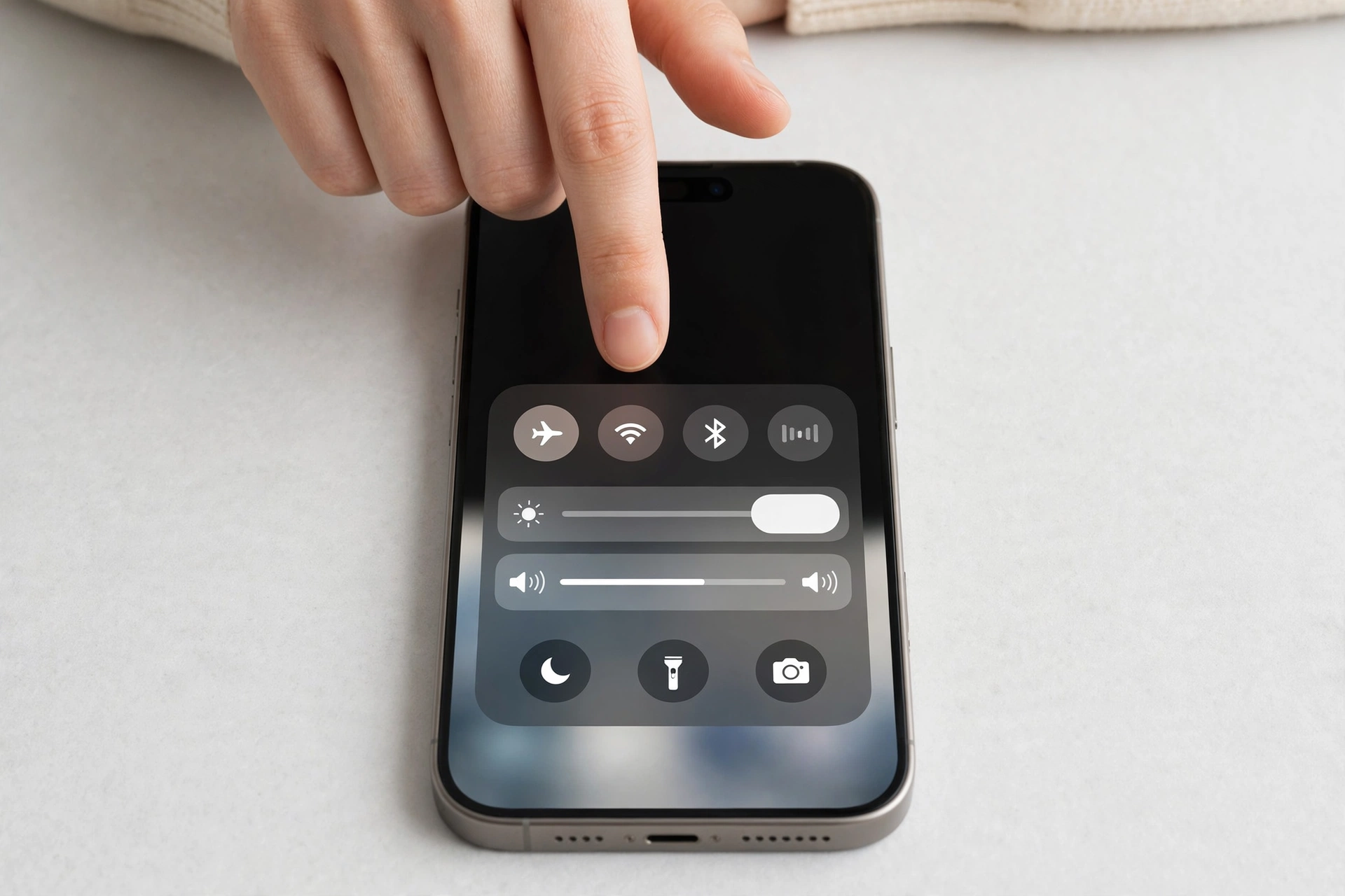 Hand swiping down from the top of a smartphone screen