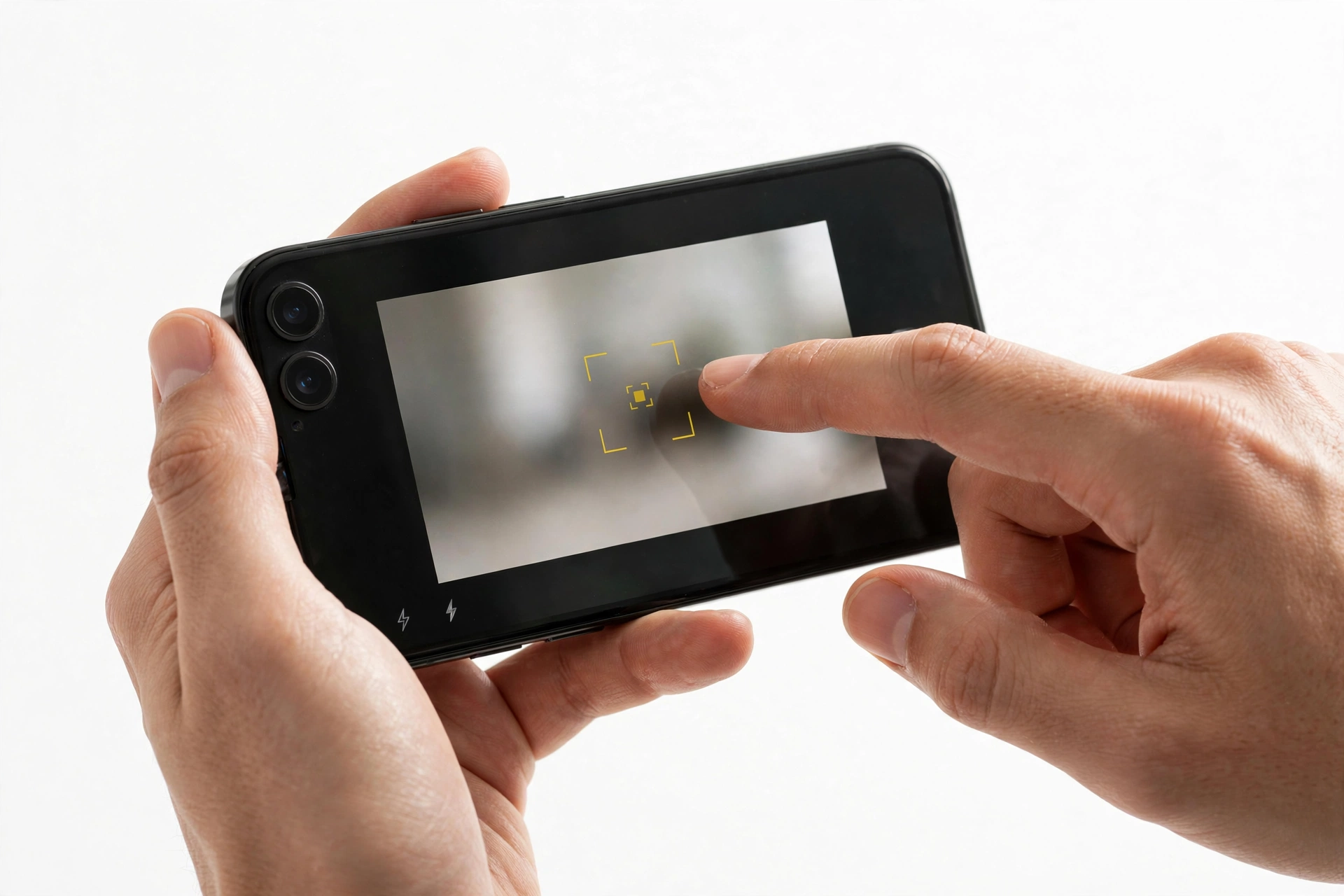 Hands holding a smartphone, tapping the camera screen to set focus