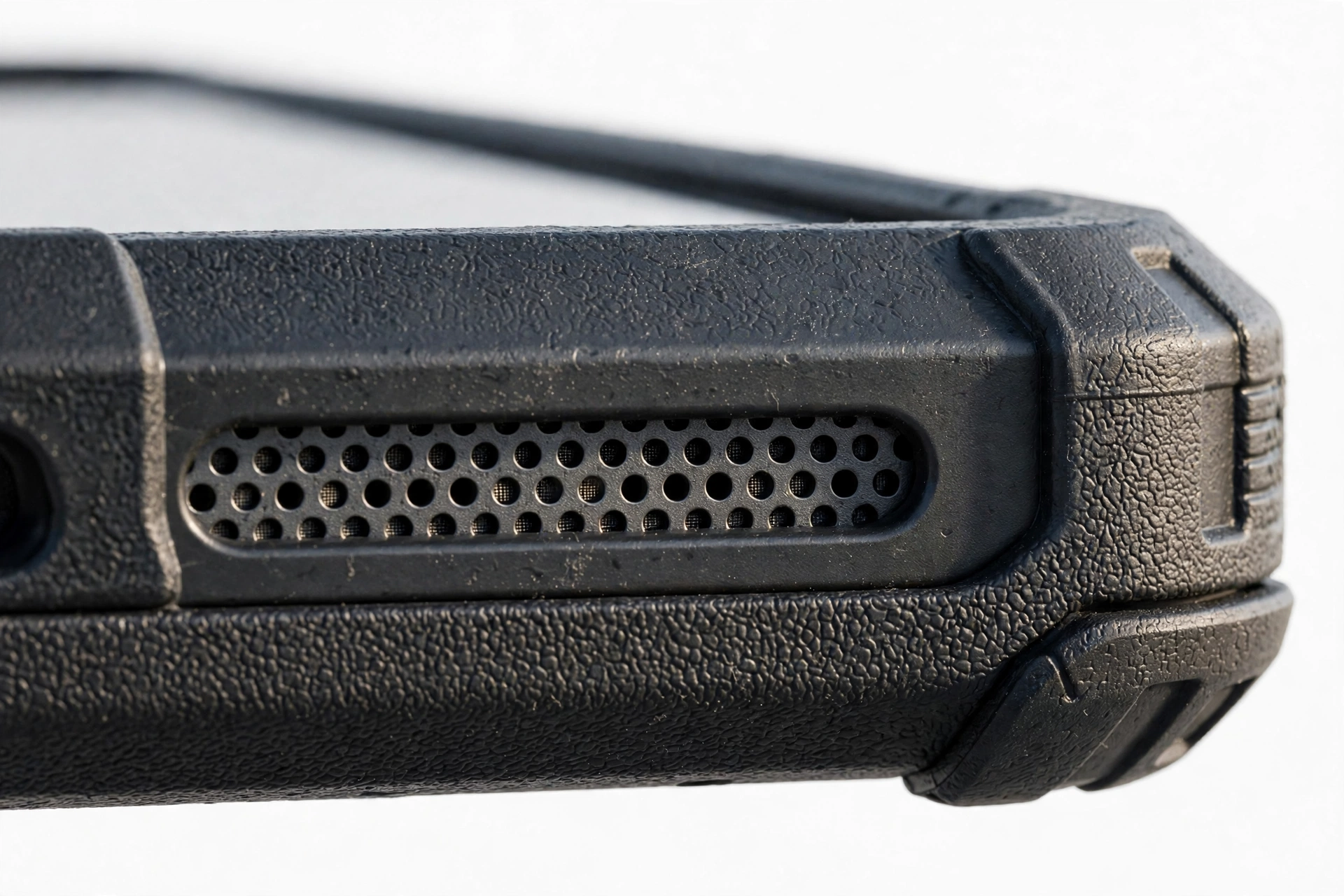 Close-up of smartphone bottom speaker grille on a rugged phone