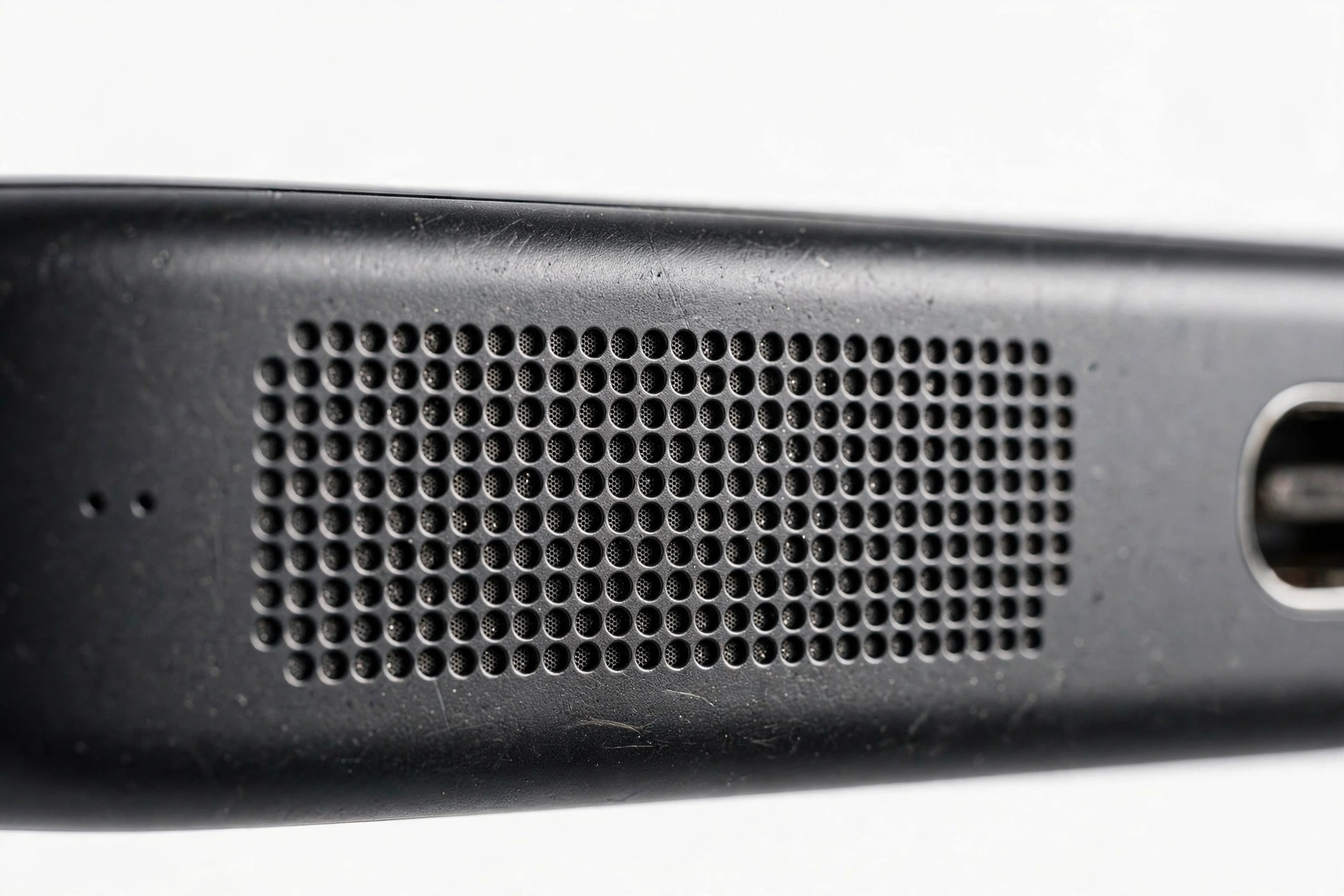 Close-up of a smartphone speaker grille holes
